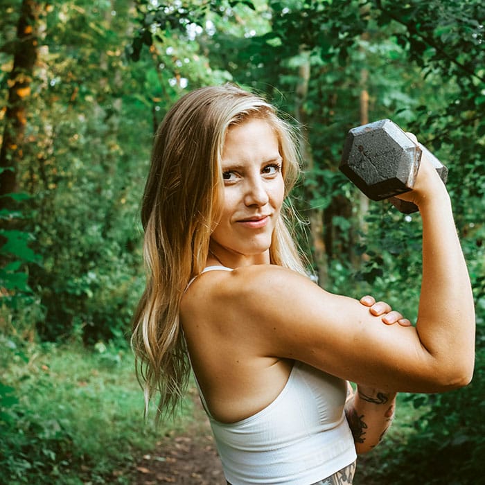 Branding photography - a fitness instructor poses with a dumbbell