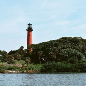 A framed photograph of the Jupiter Inlet Lighthouse in Florida