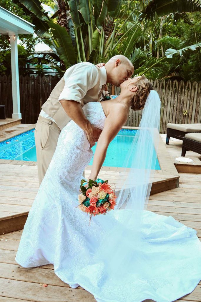 A groom kisses a bride at a Florida wedding