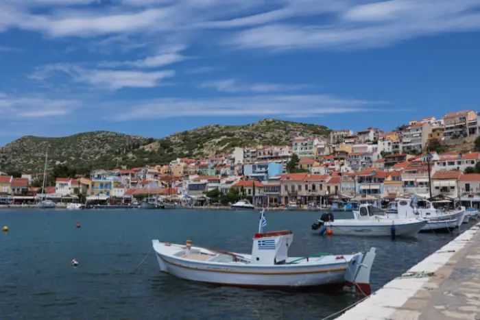 A small harbor town in Greece. Fishing boats are visible in the foreground.