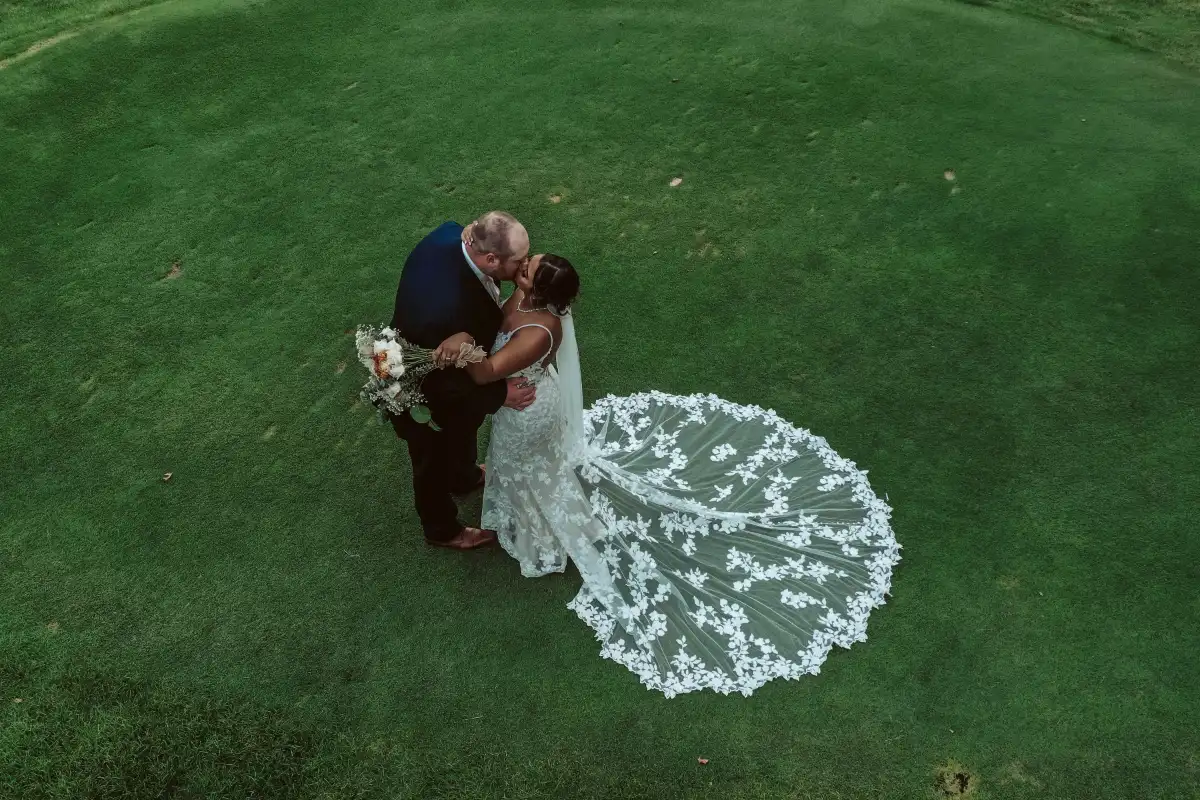 A bride and groom embrace. Photo taken at their wedding, using a drone